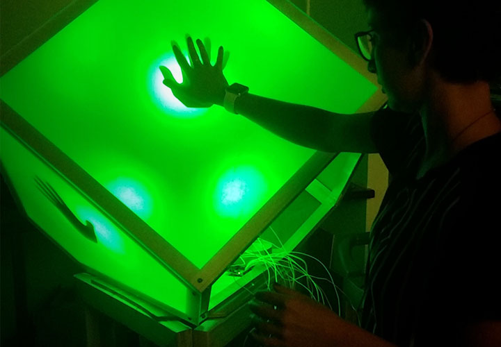 Image of girl touching illuminated sculpture